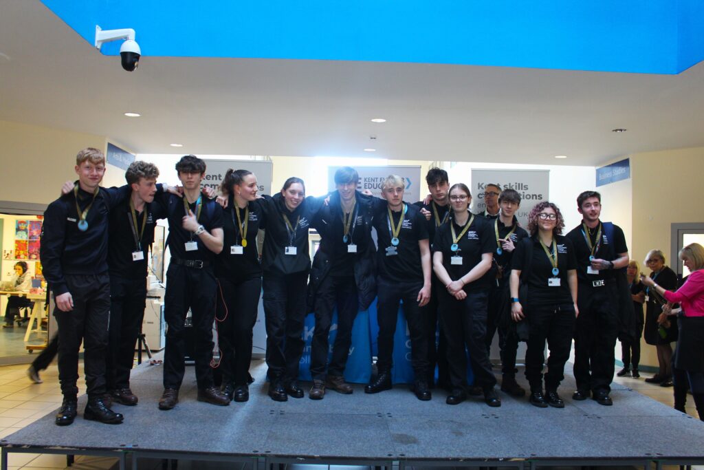 Group of students stood on a satge