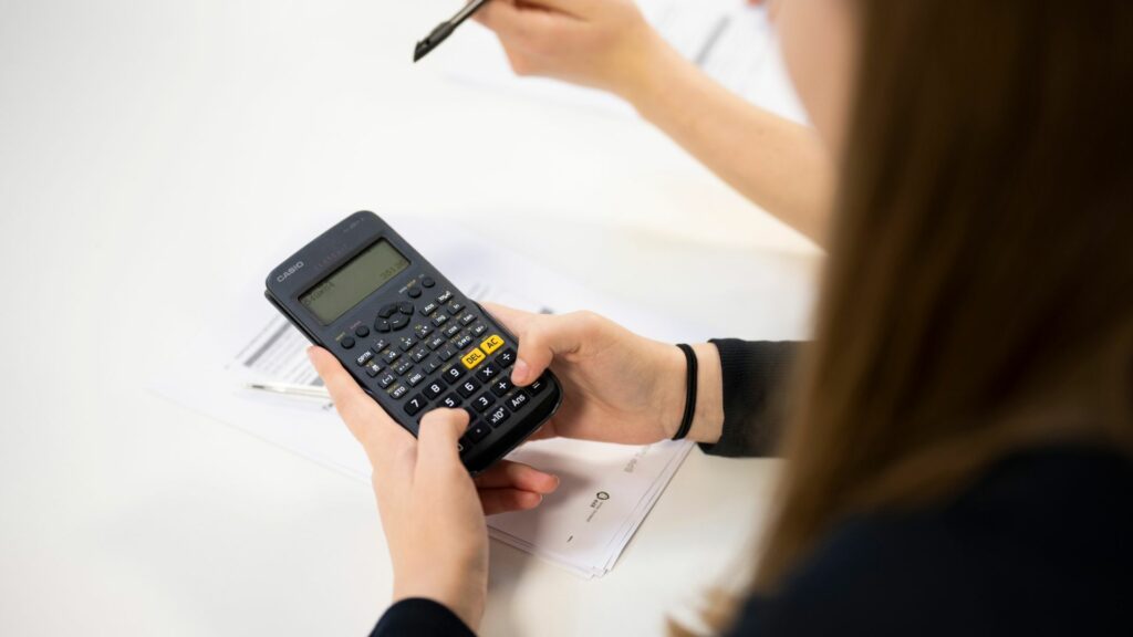 English, ESOL and Maths student using calculator