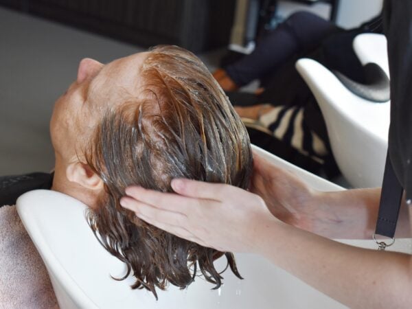 Lady getting her hair washed at the EKC Folkestone College salon.